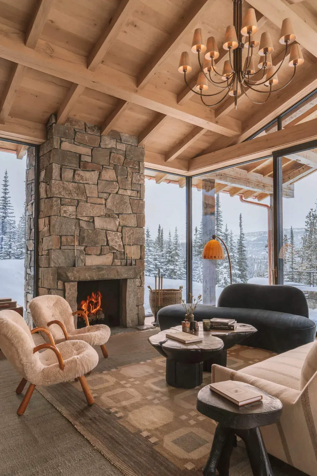 Timber great room with stone fireplace at a high alpine ranch